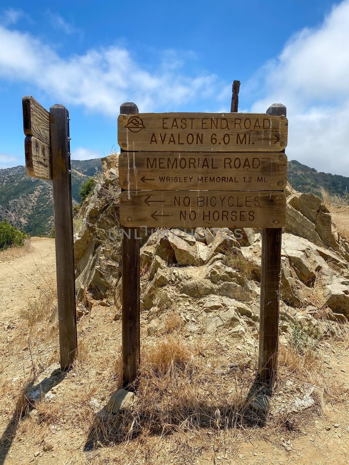 Wooden sign board with direction on the hiking trails on the top of Santa Catalina Island mountains by Bonandbon