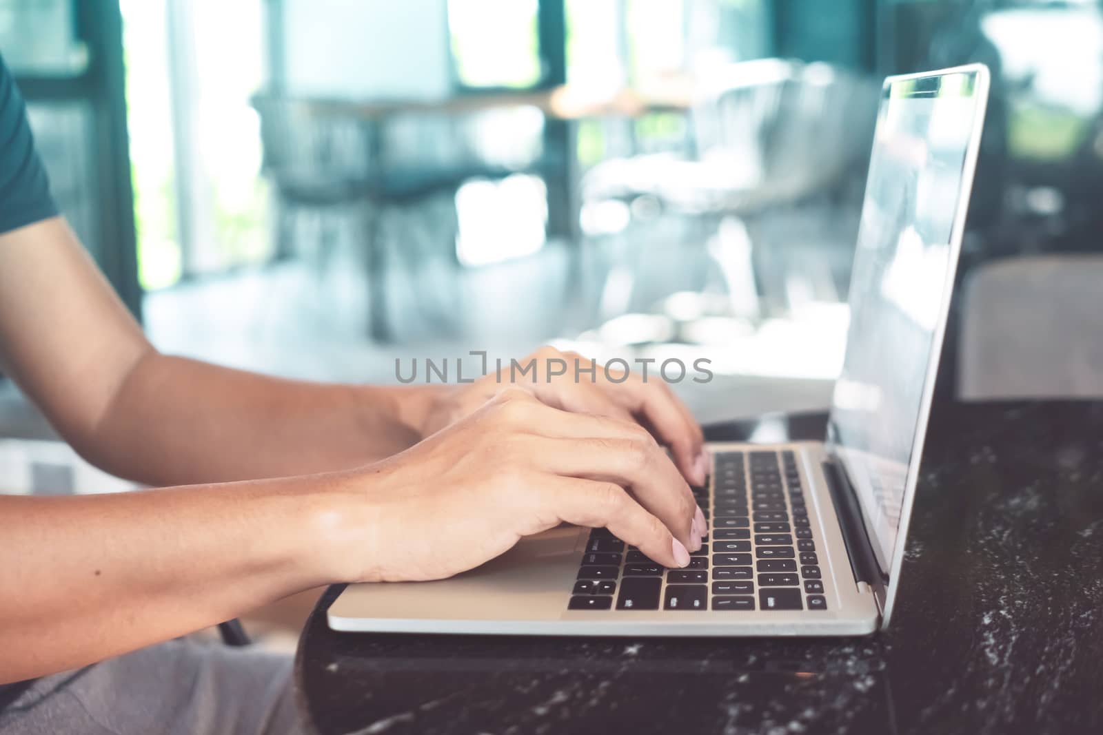 Woman hand using laptop to work study on work desk with clean nature background background. Business, financial, trade stock maket and social network. by Suwant