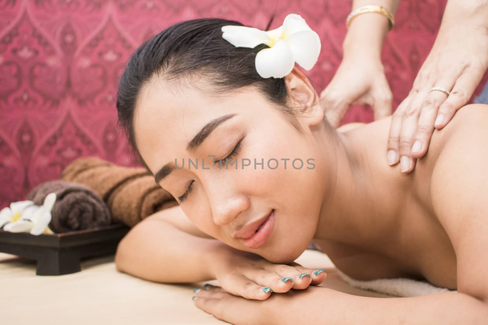 happy attractive asian woman relaxing and having massage in spa salon