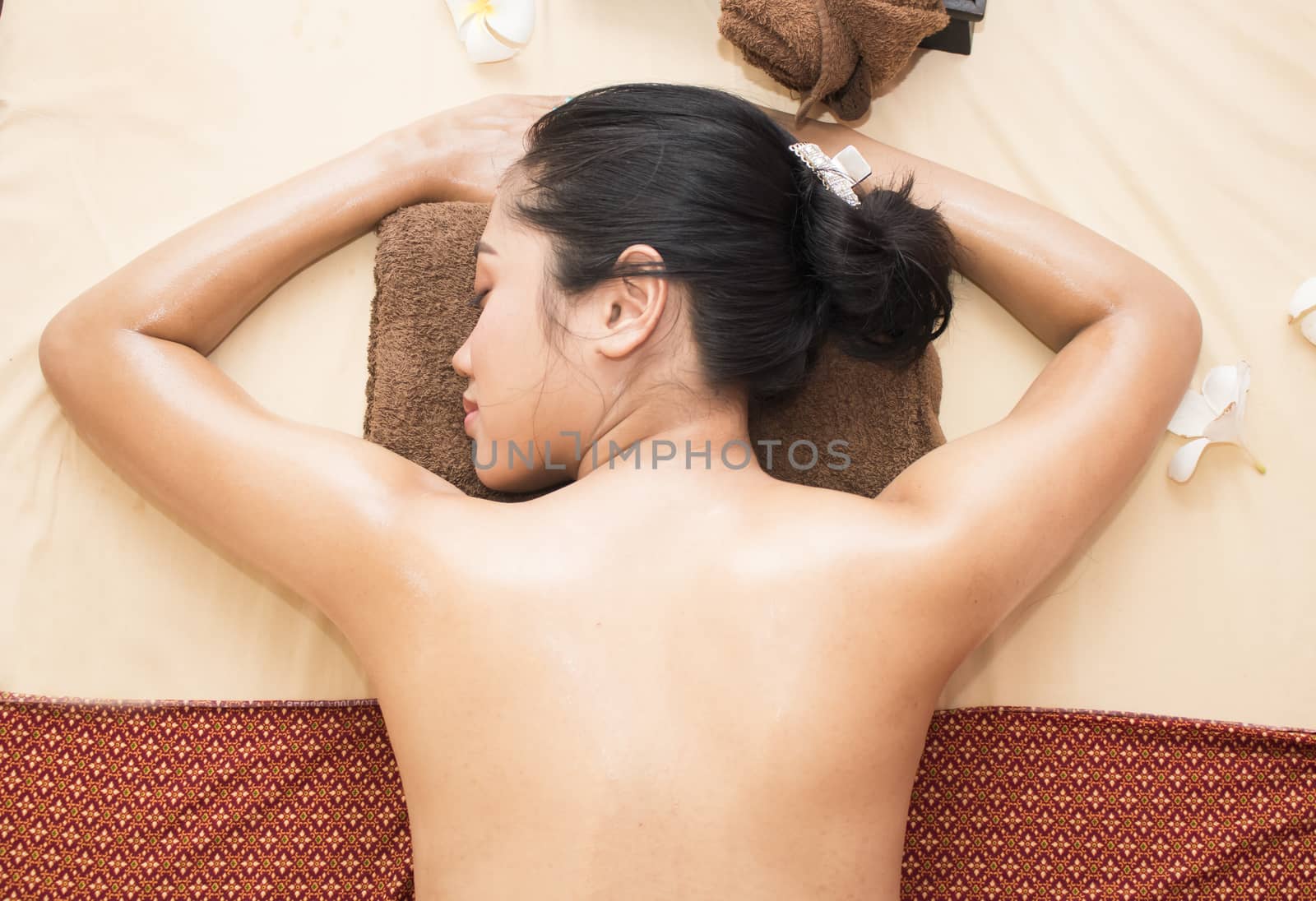 Young beautiful asian woman relaxing in spa salon