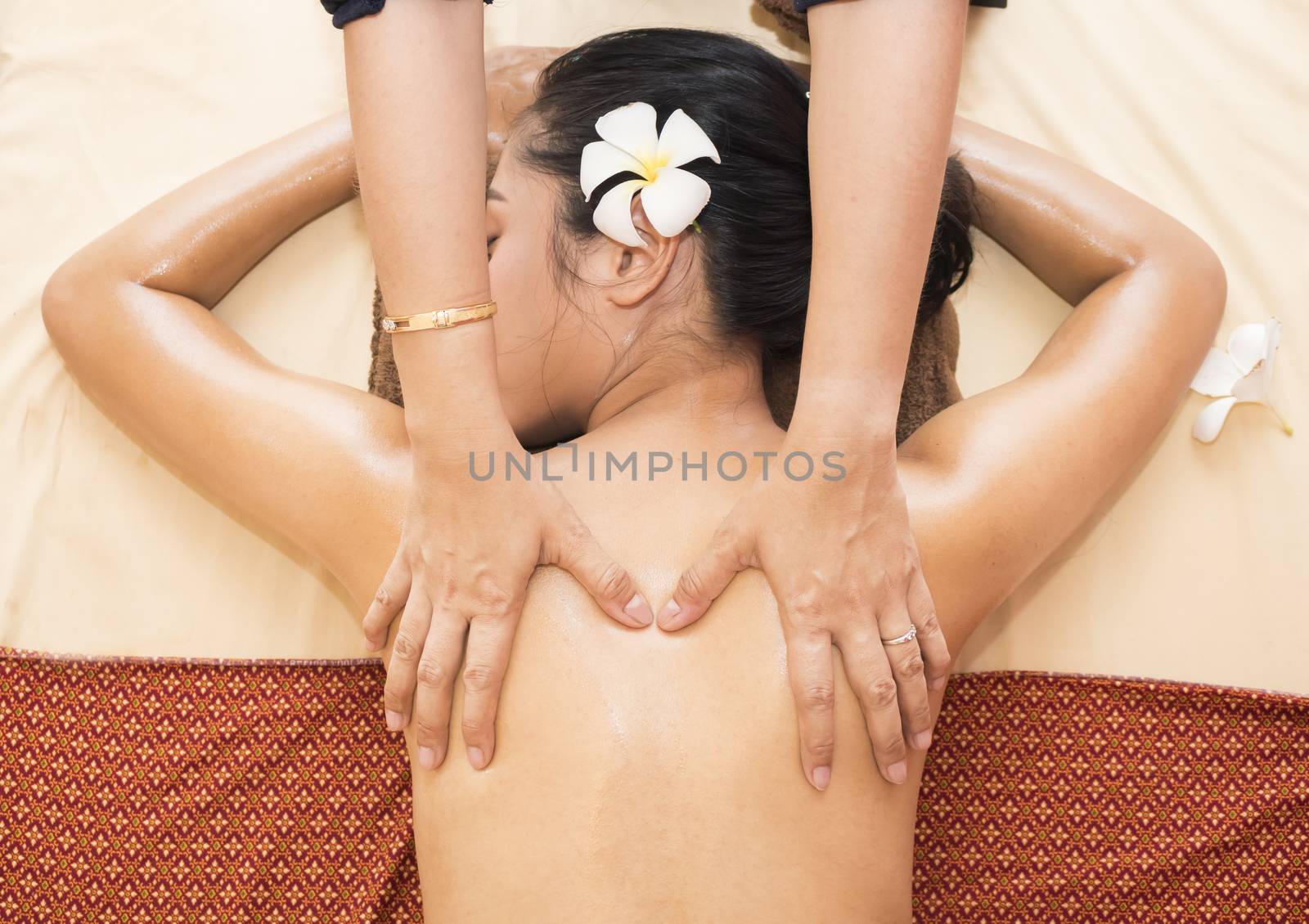 Beautiful young asian girl having massage in spa salon,top view