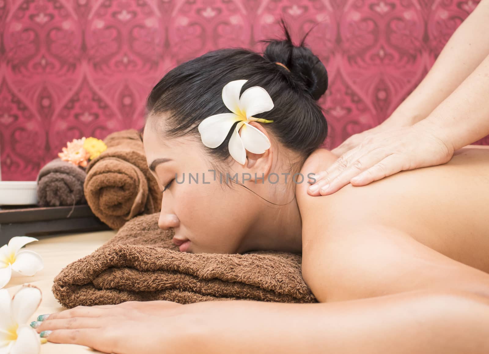 Young asian woman getting a massage in a spa
