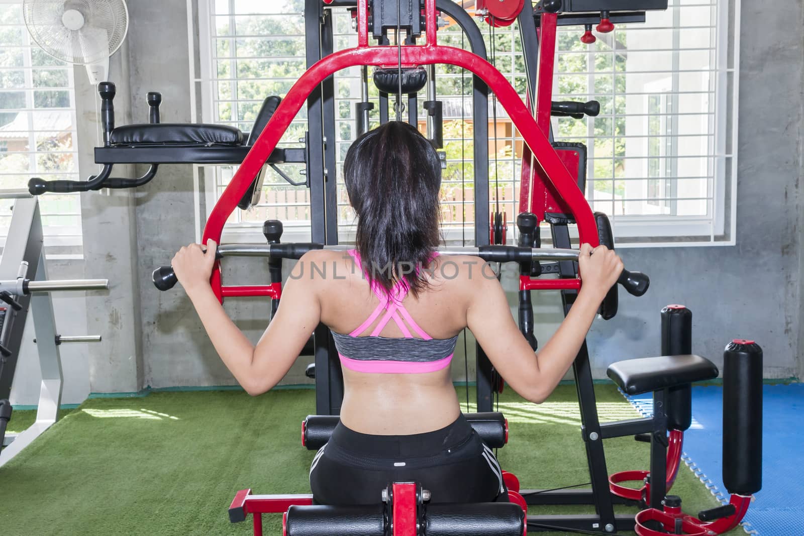 Young woman training in a gym,behind view
