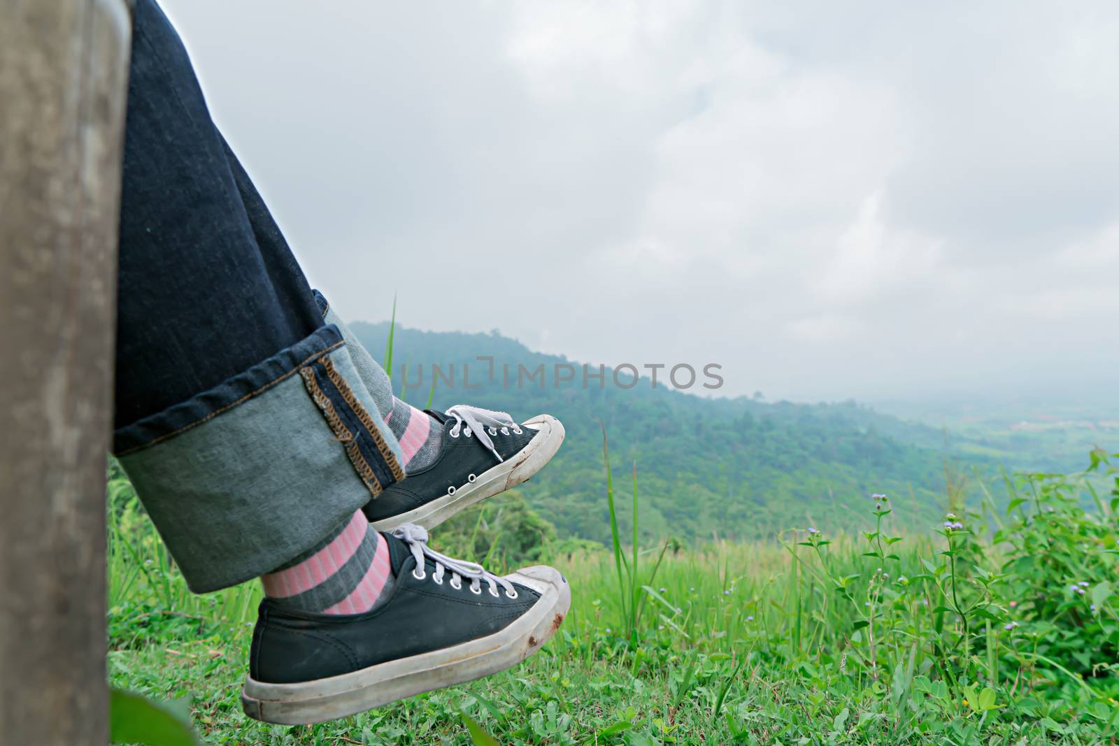 Traveler foot with green mountain.  Relax outdoor concept by Buttus_casso