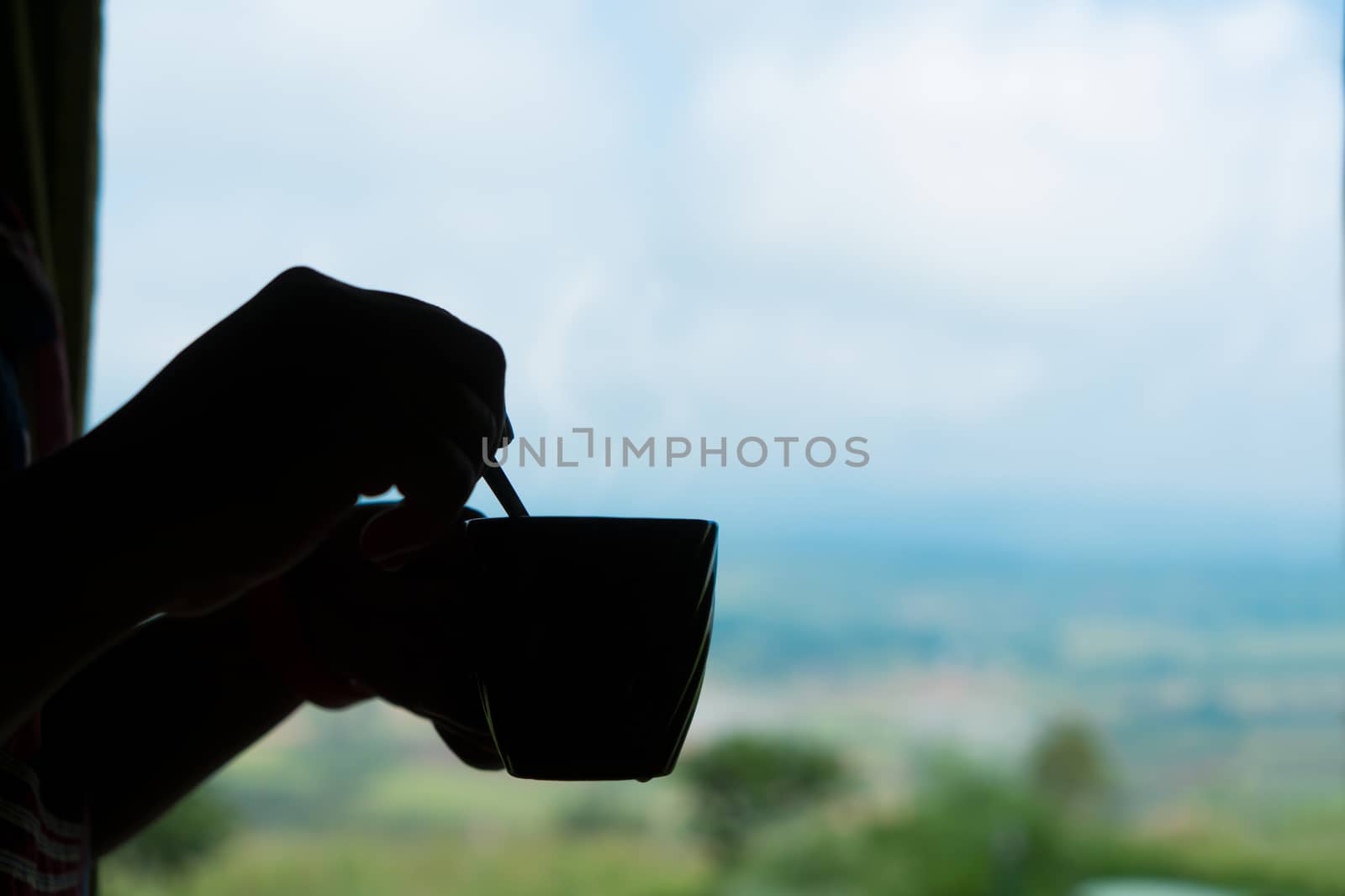 Silhouette hand drink coffee in morning