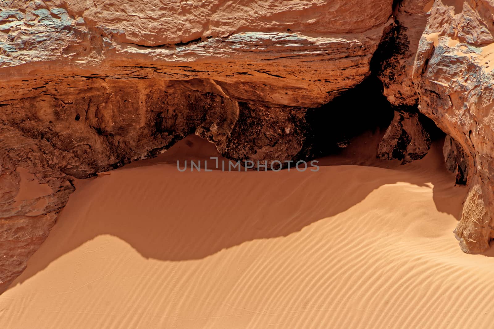 Rock and fine sand with ripple marks and wind ripples in the desert of Wadi Rum, Jordan by geogif