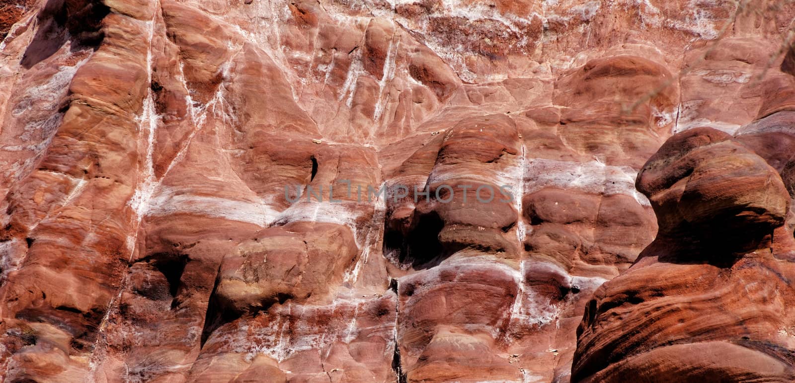 Laminated sandstone in Petra, Jordan, with strong red, yellow, orange and brown colours by geogif