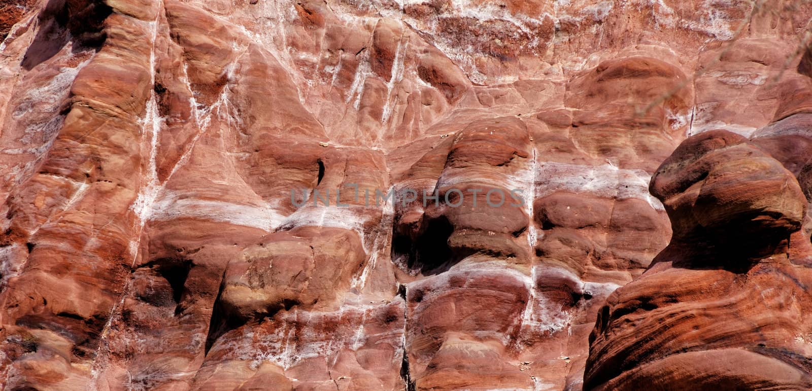 Laminated sandstone in Petra, Jordan, with strong red, yellow, orange and brown colours, middle east