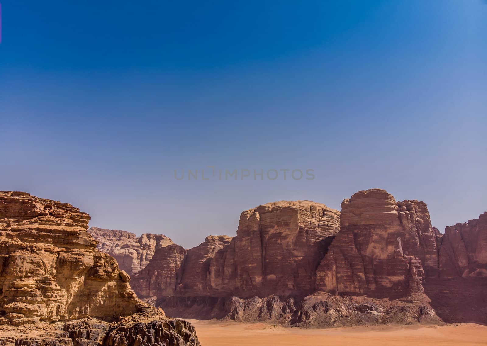 Aerial view, taken with the drone, of rock formations and monolithic mountains in the desert of Wadi Rum, Jordan by geogif