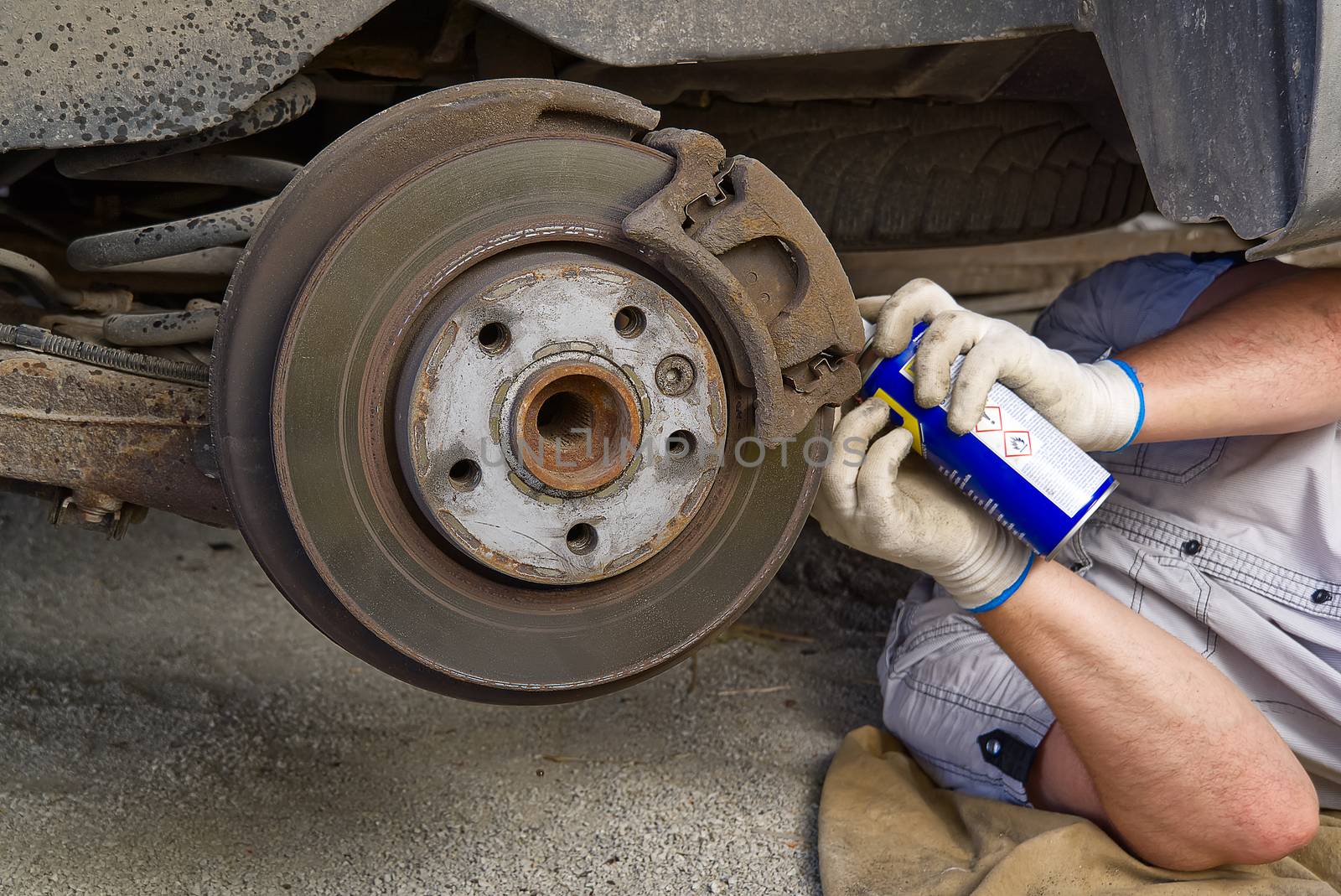 Old and dirty rear dump break of the vehicle for repair. Brakes on a car with removed wheel. Detail image of cars break assembly before repair