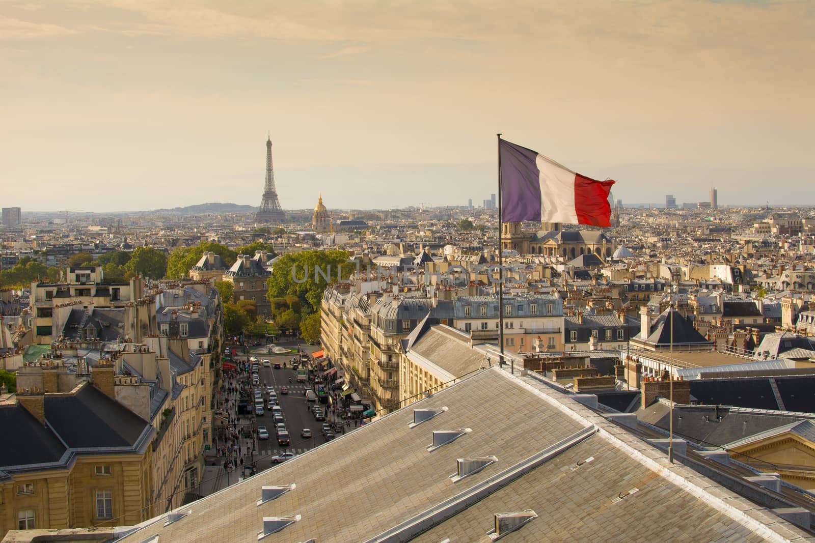 Paris, France, view on skyline and cityscape from the Pantheon, French flag waving in foreground