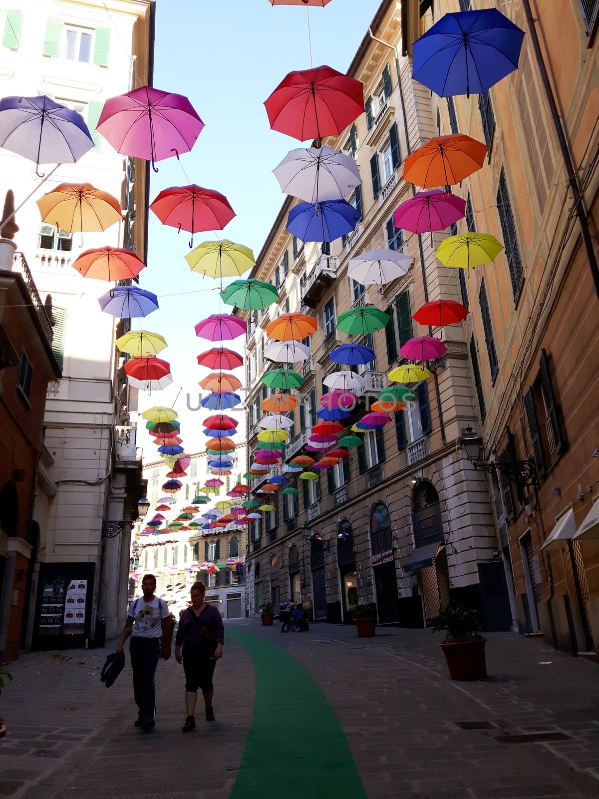 Genova, Italy - 06/25/2020:Bright abstract background of jumble of rainbow colored umbrellas over the city celebrating gay pride