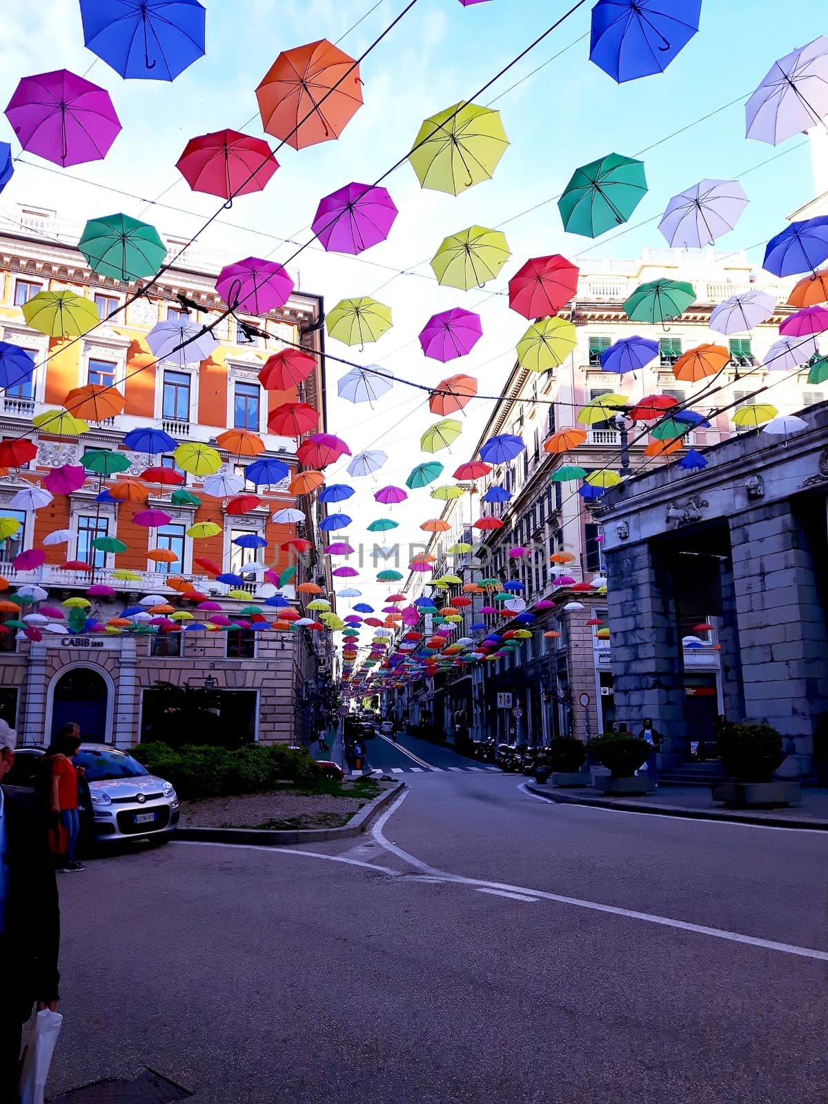 Genova, Italy - 06/25/2020:Bright abstract background of jumble of rainbow colored umbrellas over the city celebrating gay pride