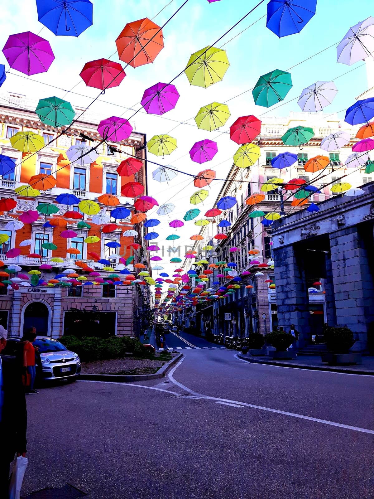 Genova, Italy - 06/25/2020:Bright abstract background of jumble of rainbow colored umbrellas over the city celebrating gay pride