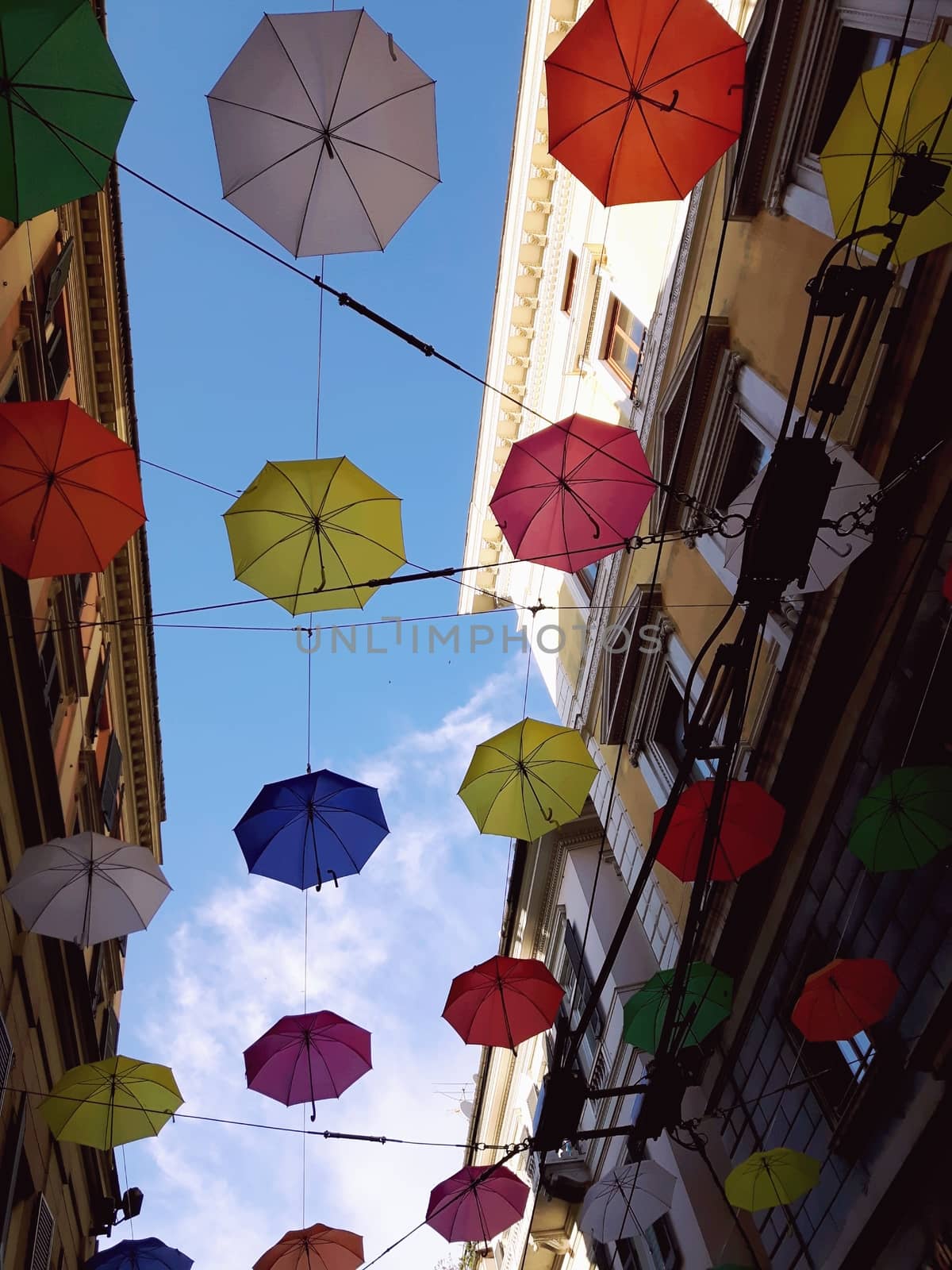 Genova, Italy - 06/25/2020:Bright abstract background of jumble of rainbow colored umbrellas over the city celebrating gay pride