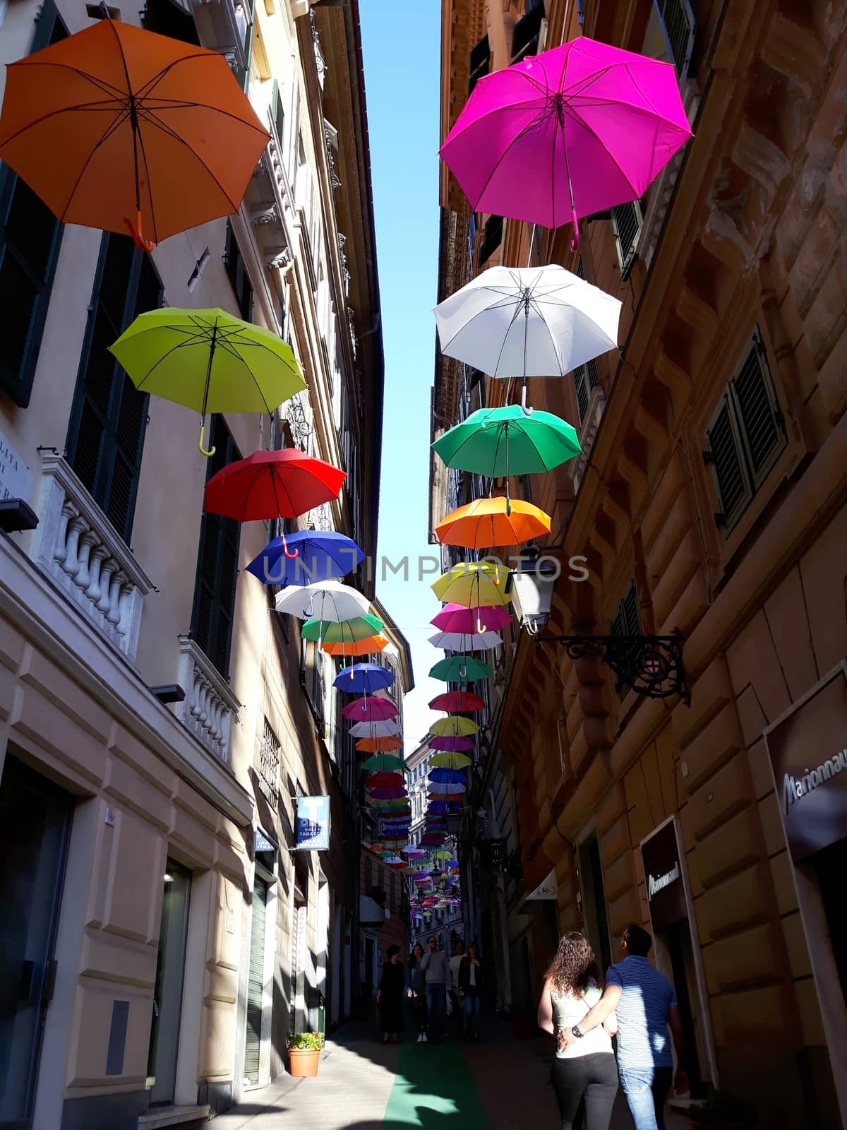 Genova, Italy - 06/25/2020:Bright abstract background of jumble of rainbow colored umbrellas over the city celebrating gay pride