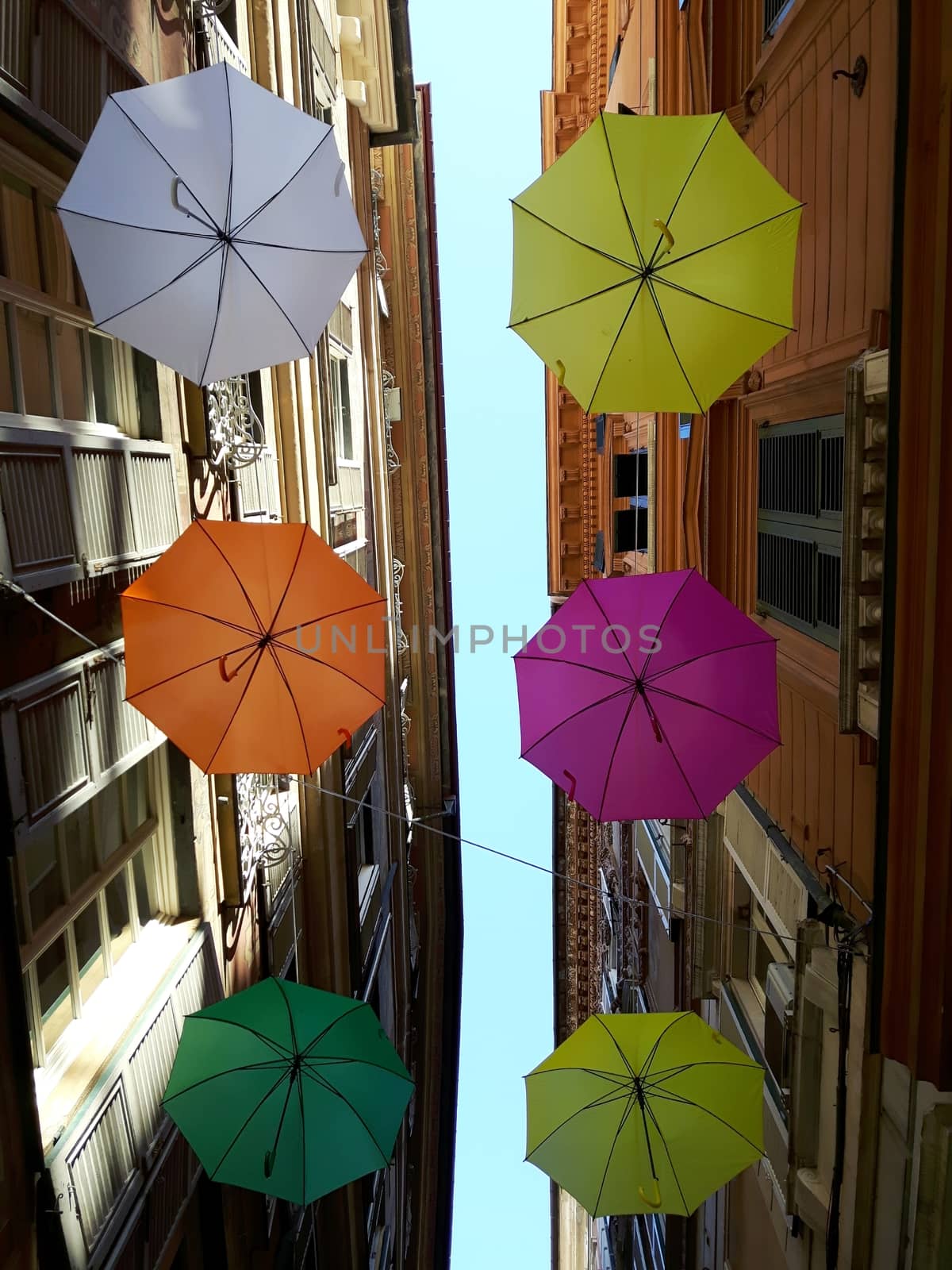 Genova, Italy - 06/25/2020:Bright abstract background of jumble of rainbow colored umbrellas over the city celebrating gay pride