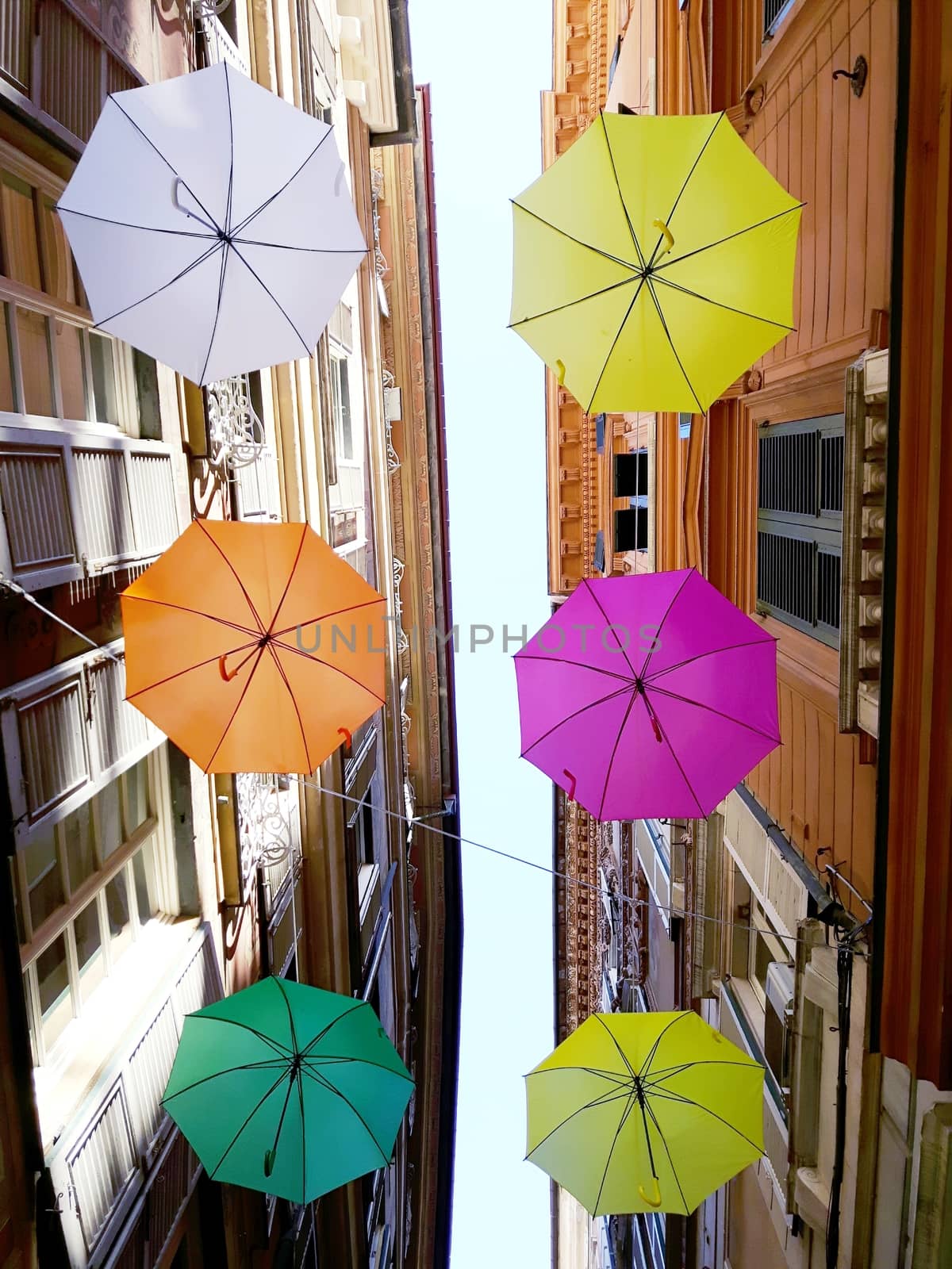 Genova, Italy - 06/25/2020:Bright abstract background of jumble of rainbow colored umbrellas over the city celebrating gay pride