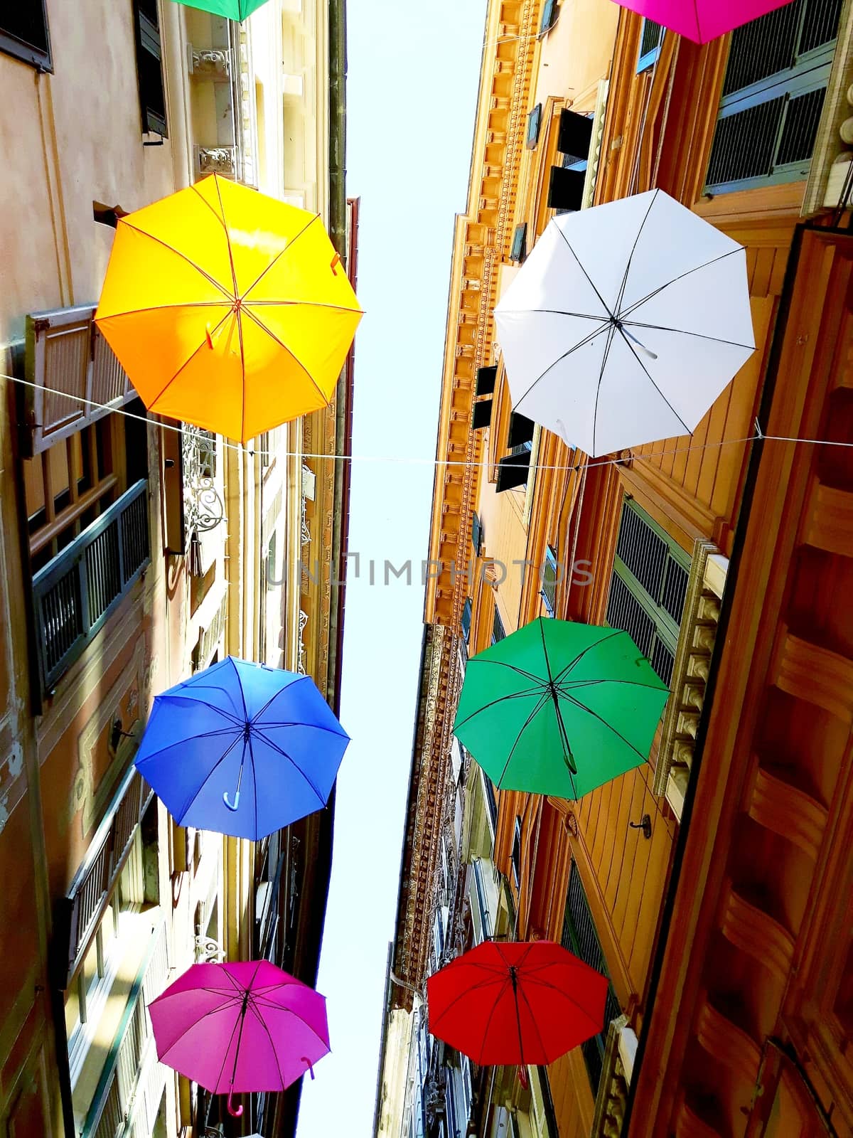 Genova, Italy - 06/25/2020:Bright abstract background of jumble of rainbow colored umbrellas over the city celebrating gay pride