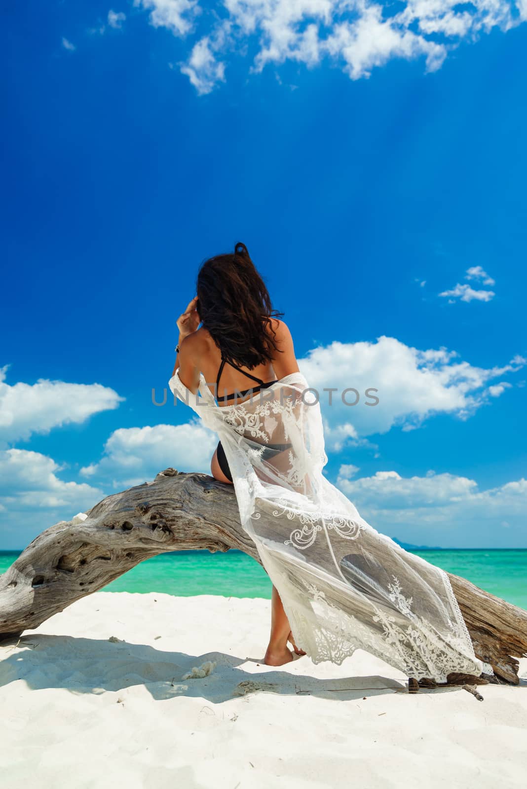 Young woman on the tropical white sand beach