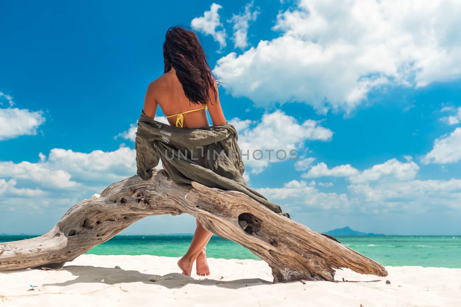 Young woman on the white sand beach by Netfalls