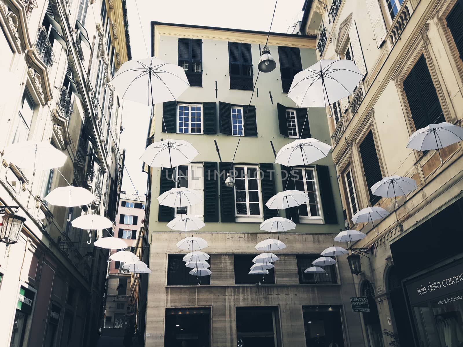 Genova, Italy - 06/01/2020: Bright abstract background of jumble of rainbow colored umbrellas over the city celebrating gay pride