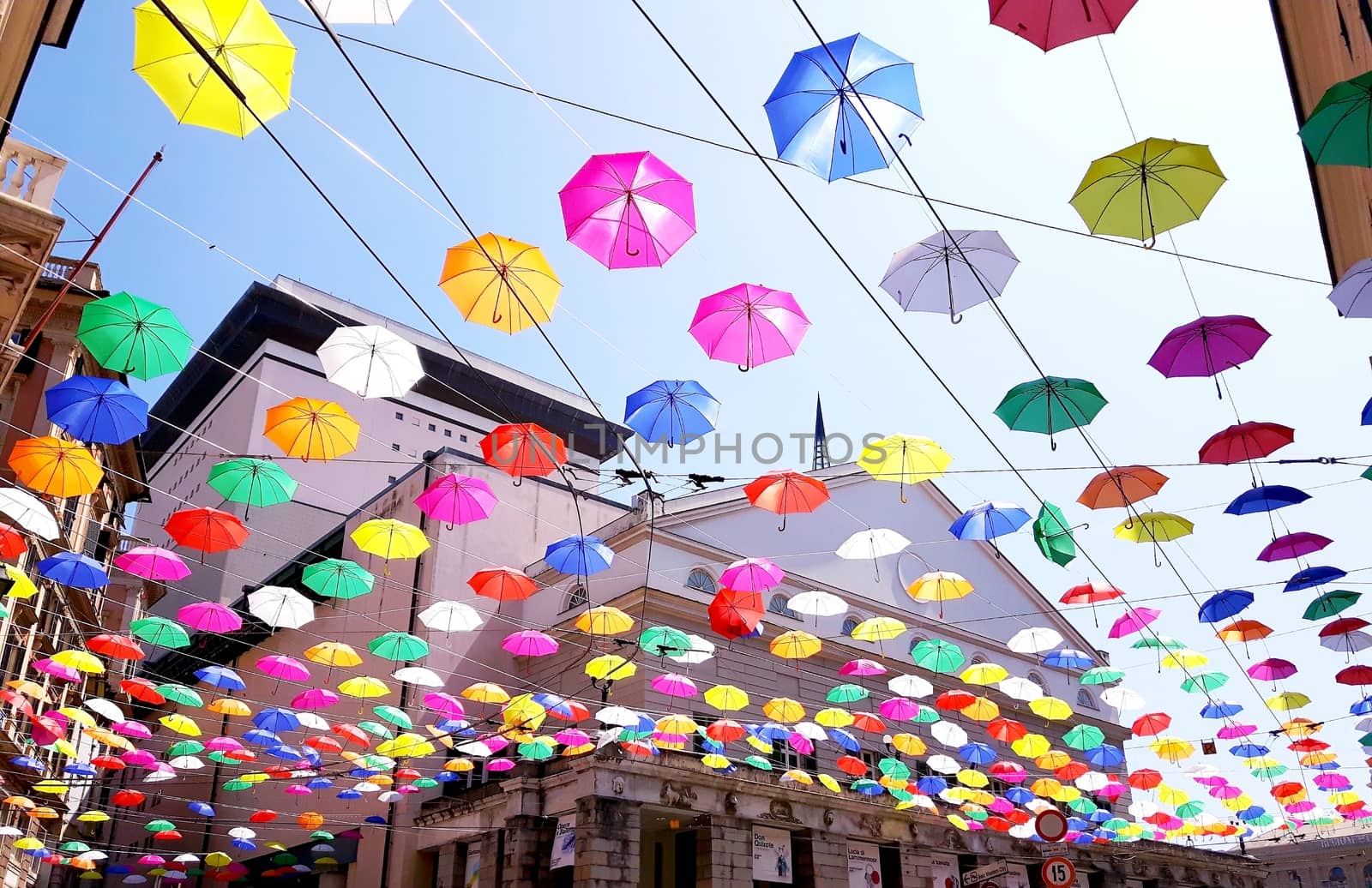 Genova, Italy - 06/01/2020: Bright abstract background of jumble of rainbow colored umbrellas over the city celebrating gay pride