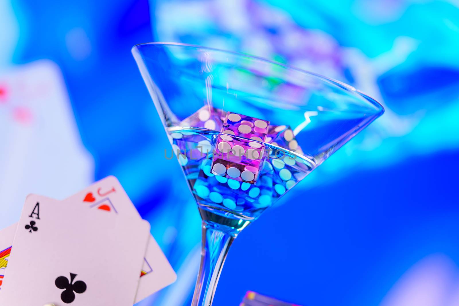 Craps dice in cocktail glass on the casino gambling table