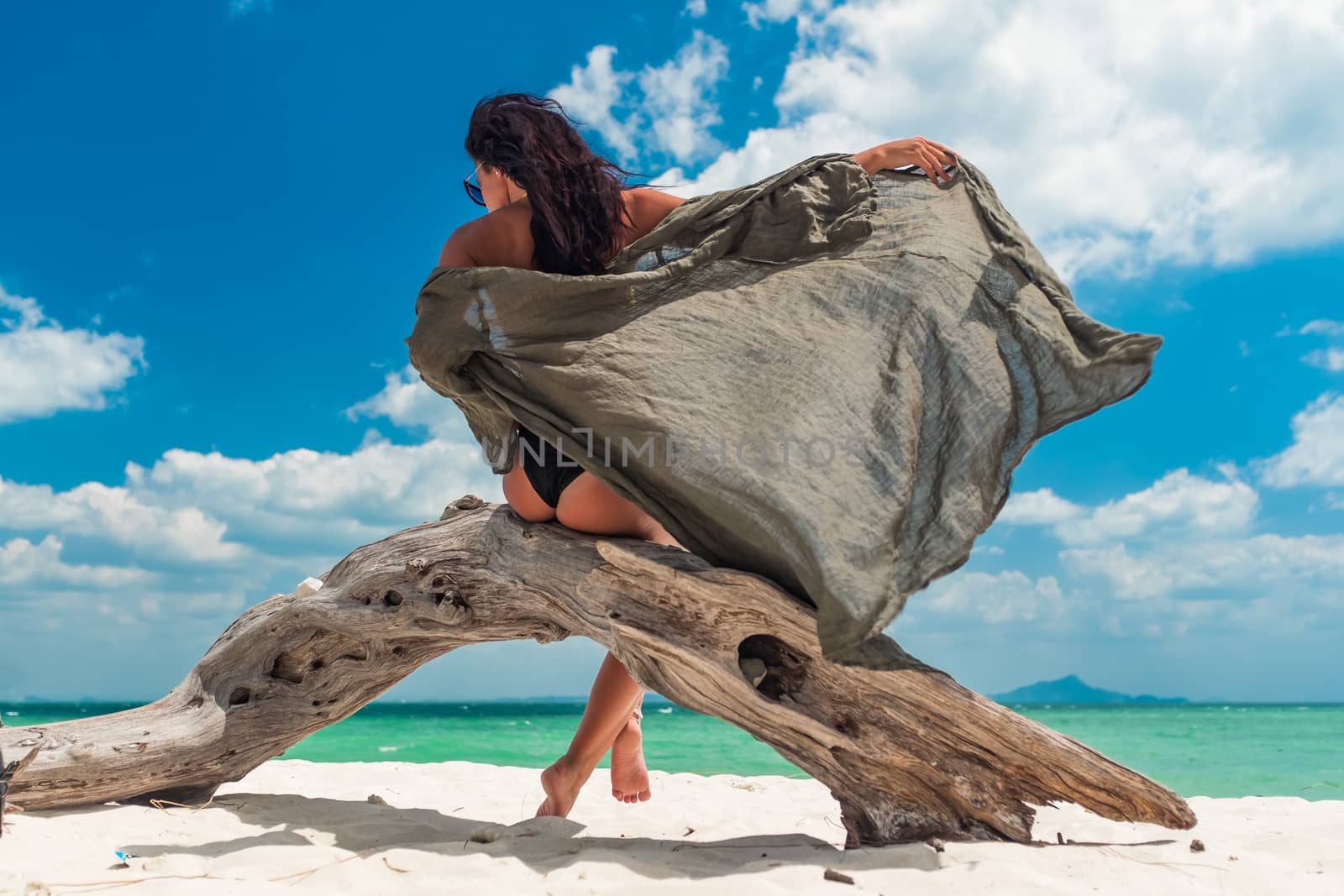 Young woman on the tropical white sand beach