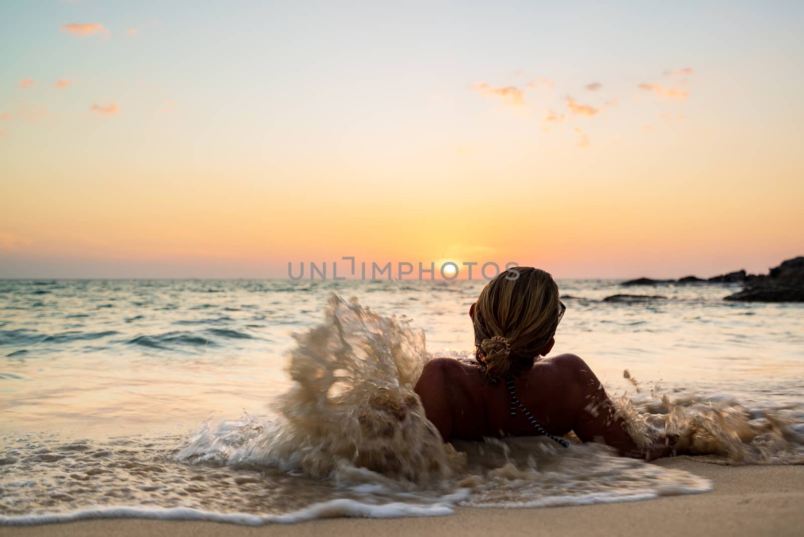 Beautiful woman on the tropical beach at sunset