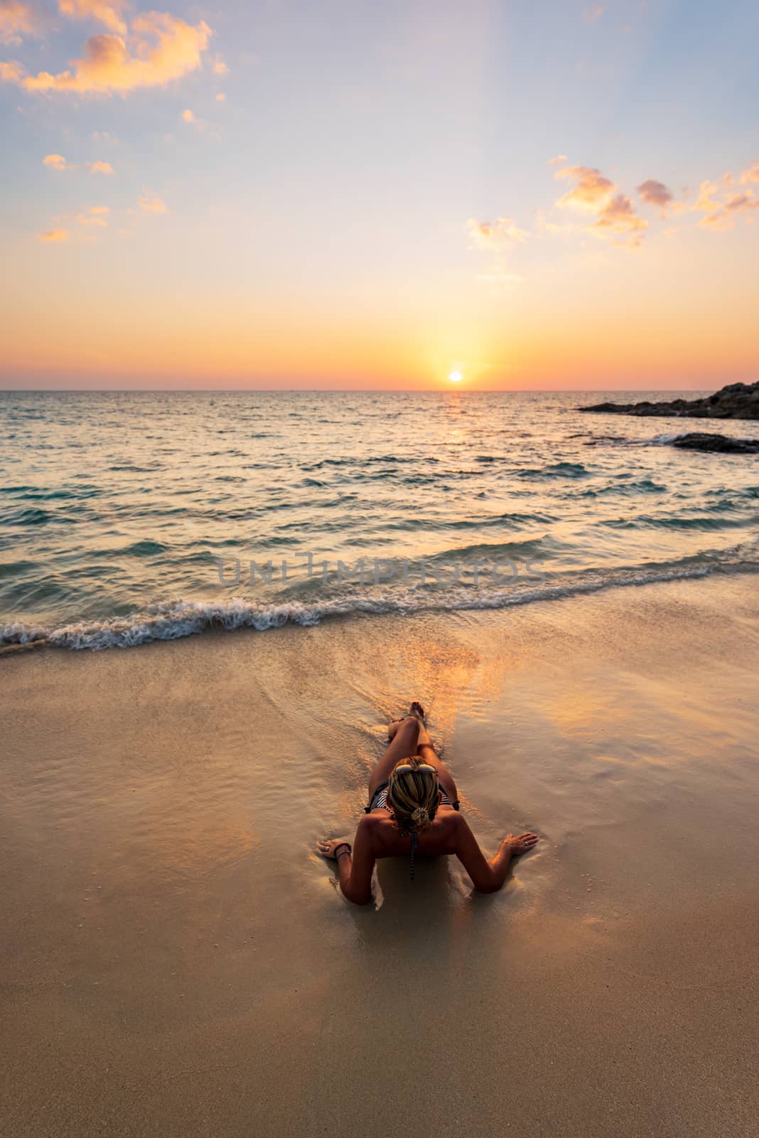 Beautiful woman on the tropical beach at sunset