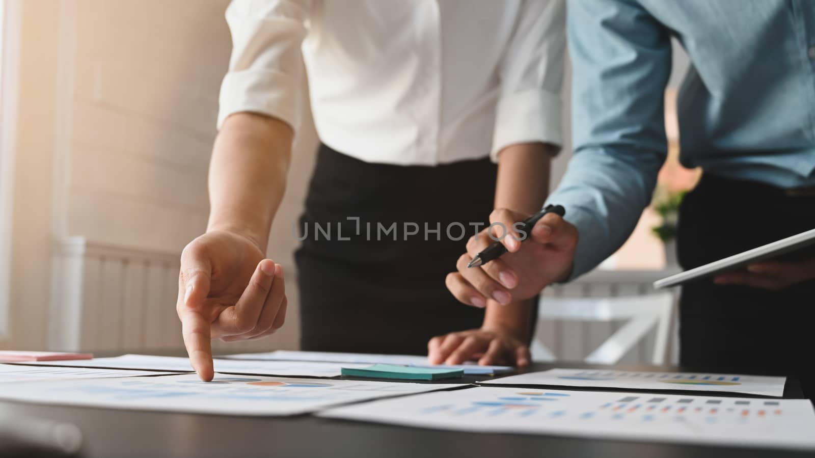 Cropped shot of business team discussing/brainstorming/examining by prathanchorruangsak