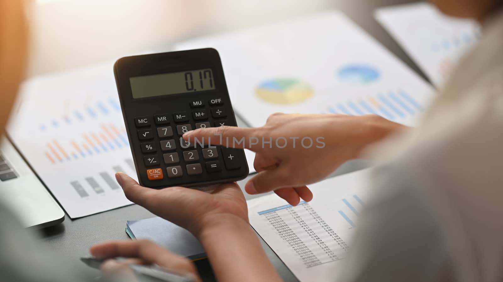 Close-up image of young business development team are calculating /discussing/brainstorming at the modern meeting table. Chart analysis concept.