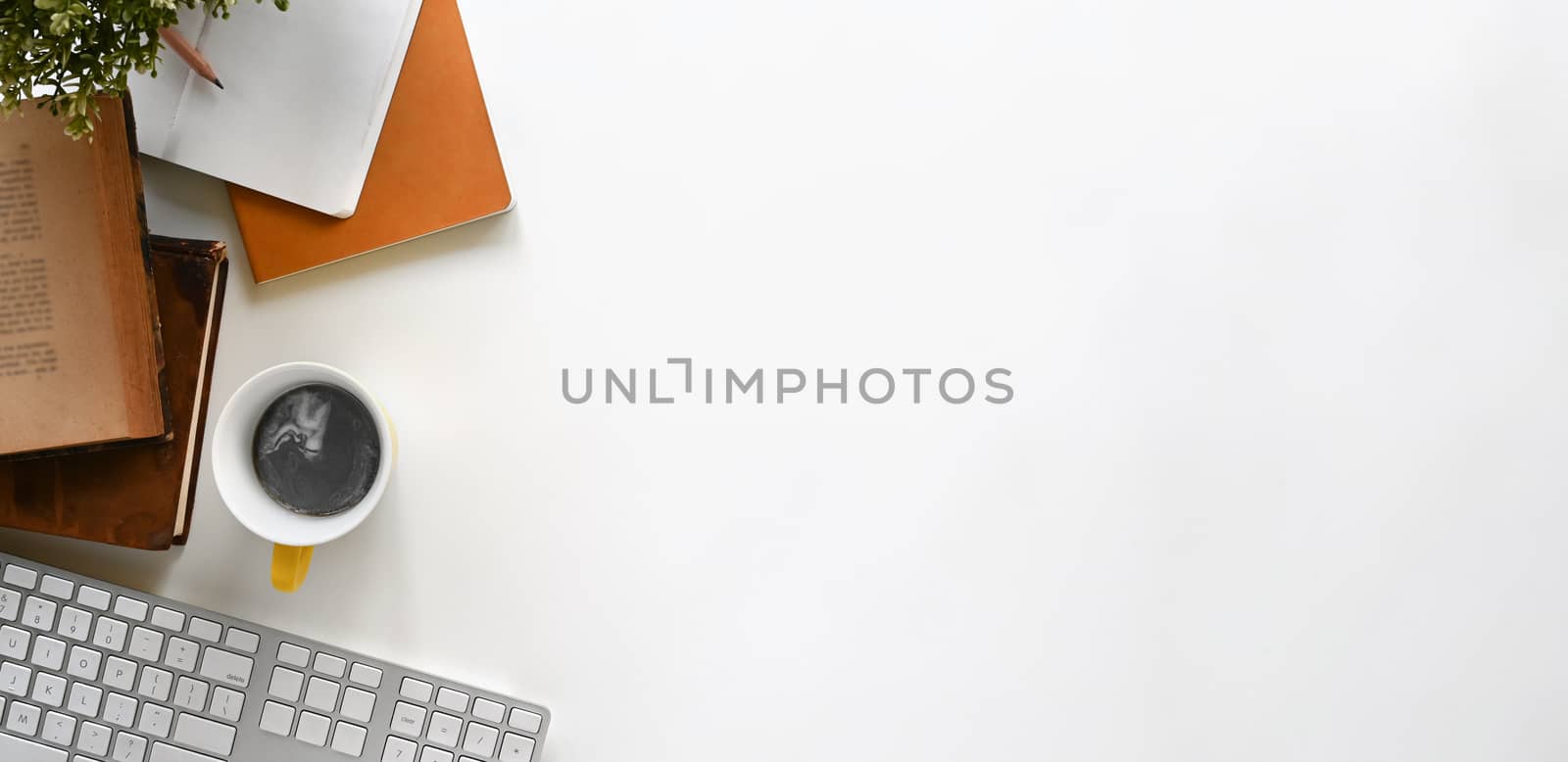 Simple Top view table - Creative flat lay office desk. computer keyboard , notebooks, books and coffee cup on white background. Panorama banner background with copy space.