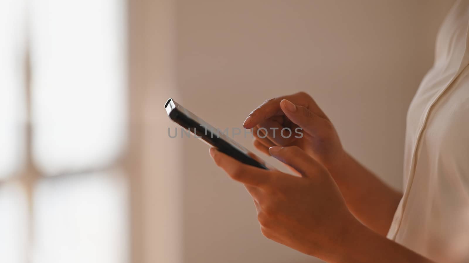 Side shot of beautiful businesswoman in white shirt surfing the  by prathanchorruangsak