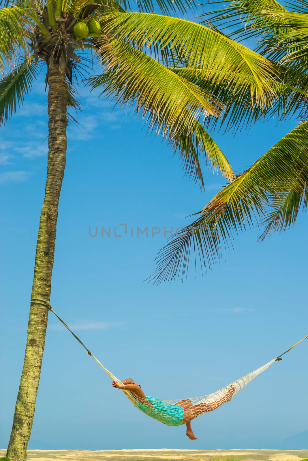 Woman on a hammock at the tropical beach