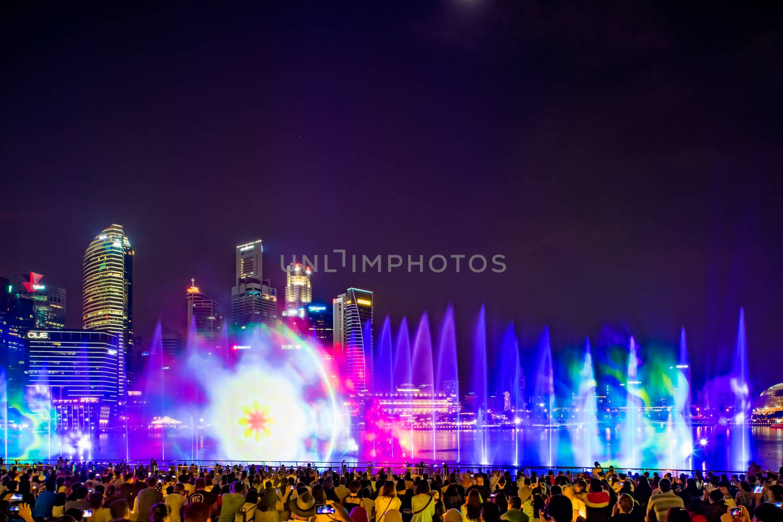 SINGAPORE CITY, SINGAPORE - MARCH 7, 2019: Front view of Spectra Light and Water Show Marina Bay Sand Casino Hotel Downtown Singapore