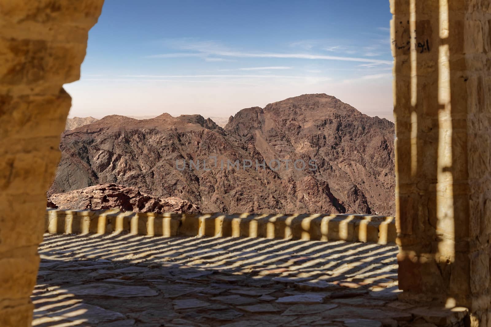 View over a terrace to the barren mountain landscape in southern Jordan, composite photograph