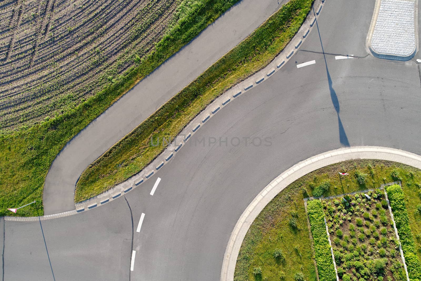 Abstract vertical aerial view of a cut roundabout next to an are by geogif