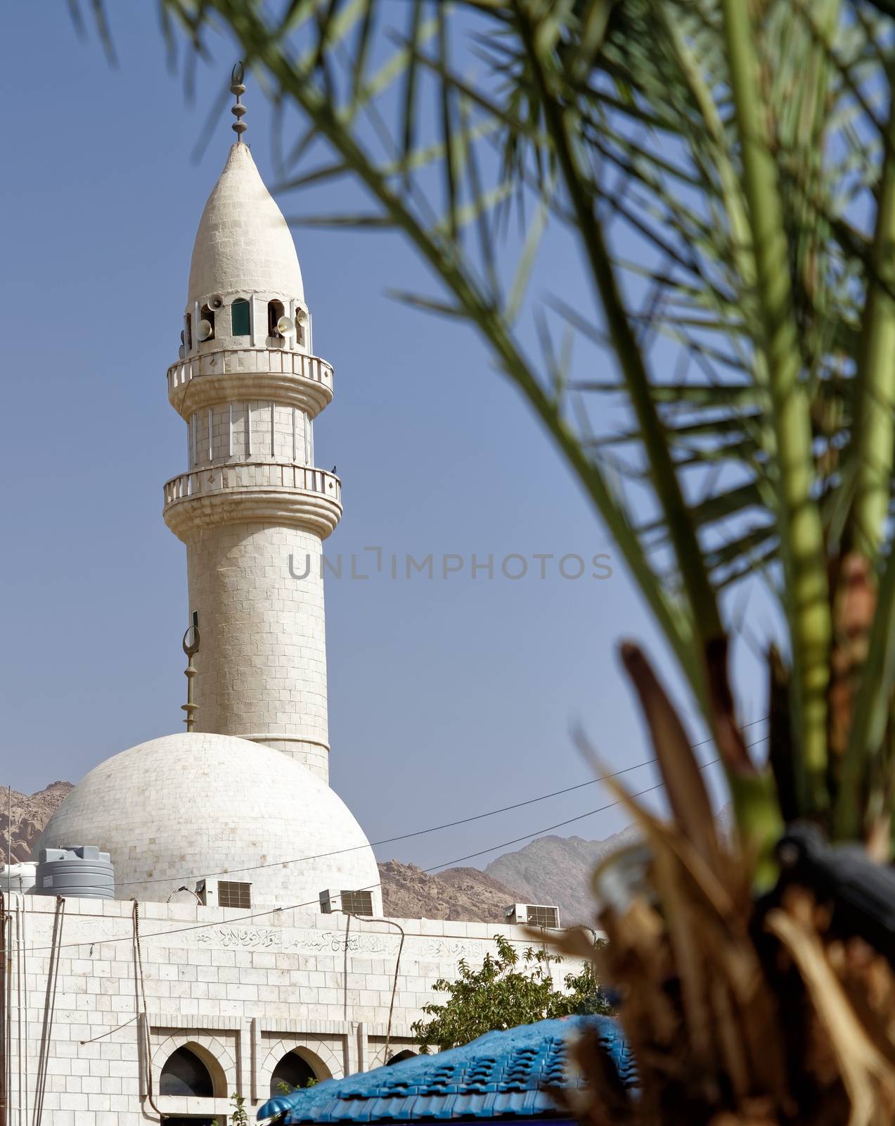 Minaret of a small mosque in a suburb of the port city Aqaba in Jordan by geogif