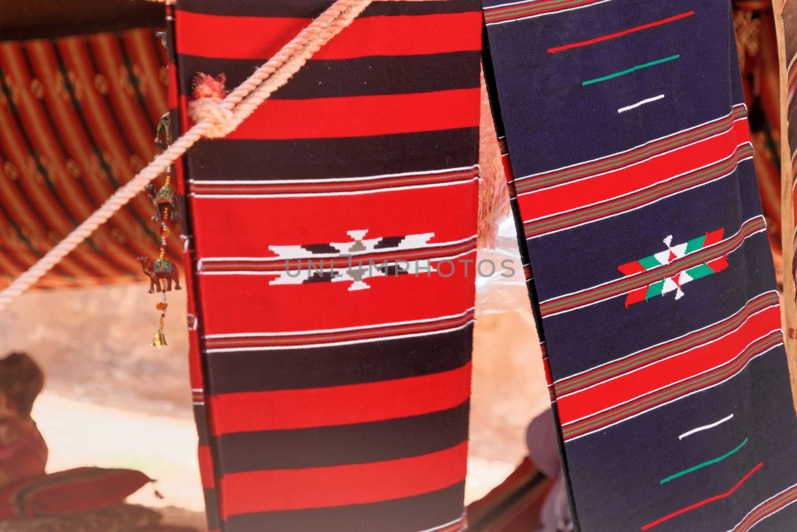 Red, blue and coloured Bedouin cloths on a tent in the desert of the Wadi Rum Nature Reserve, Jordan, middle east