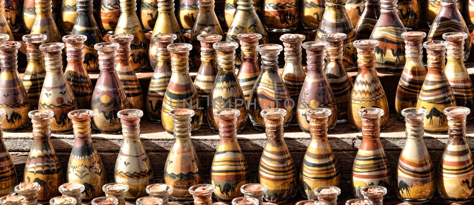 Bedouin stall with sand painting in bottles with layered coloured sand in the rock town and necropolis of Petra by geogif