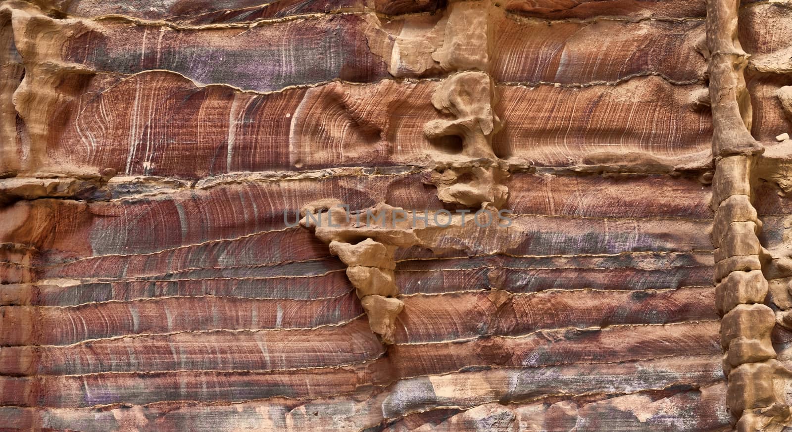 Laminated sandstone in Petra, Jordan, with strong red, yellow, orange and brown colours by geogif