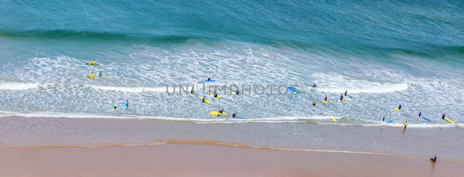 Surfers in the waves off Mawgan Porth Beach, Cornwall, UK by magicbones