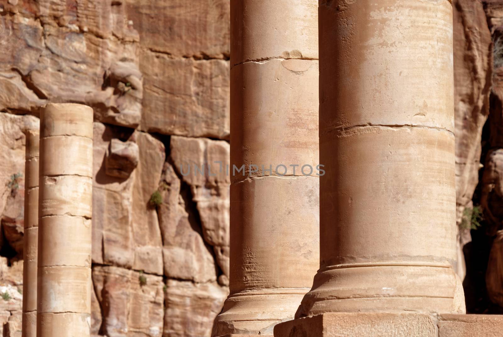 Roman columns next to the Nabataean amphitheatre in the rock town and necropolis of Petra , Jordan, middle east