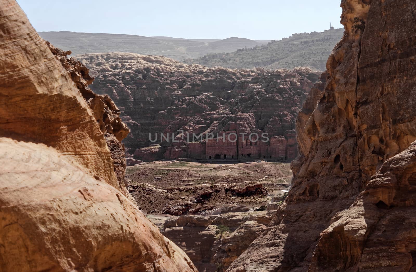 View between rocks from a distance to the centre of the Necropolis of Petra, Jordan, middle east