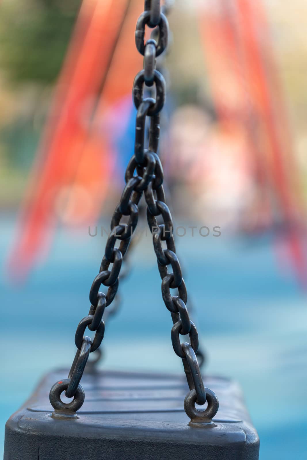 Blurred image of swings in a playground setting by magicbones