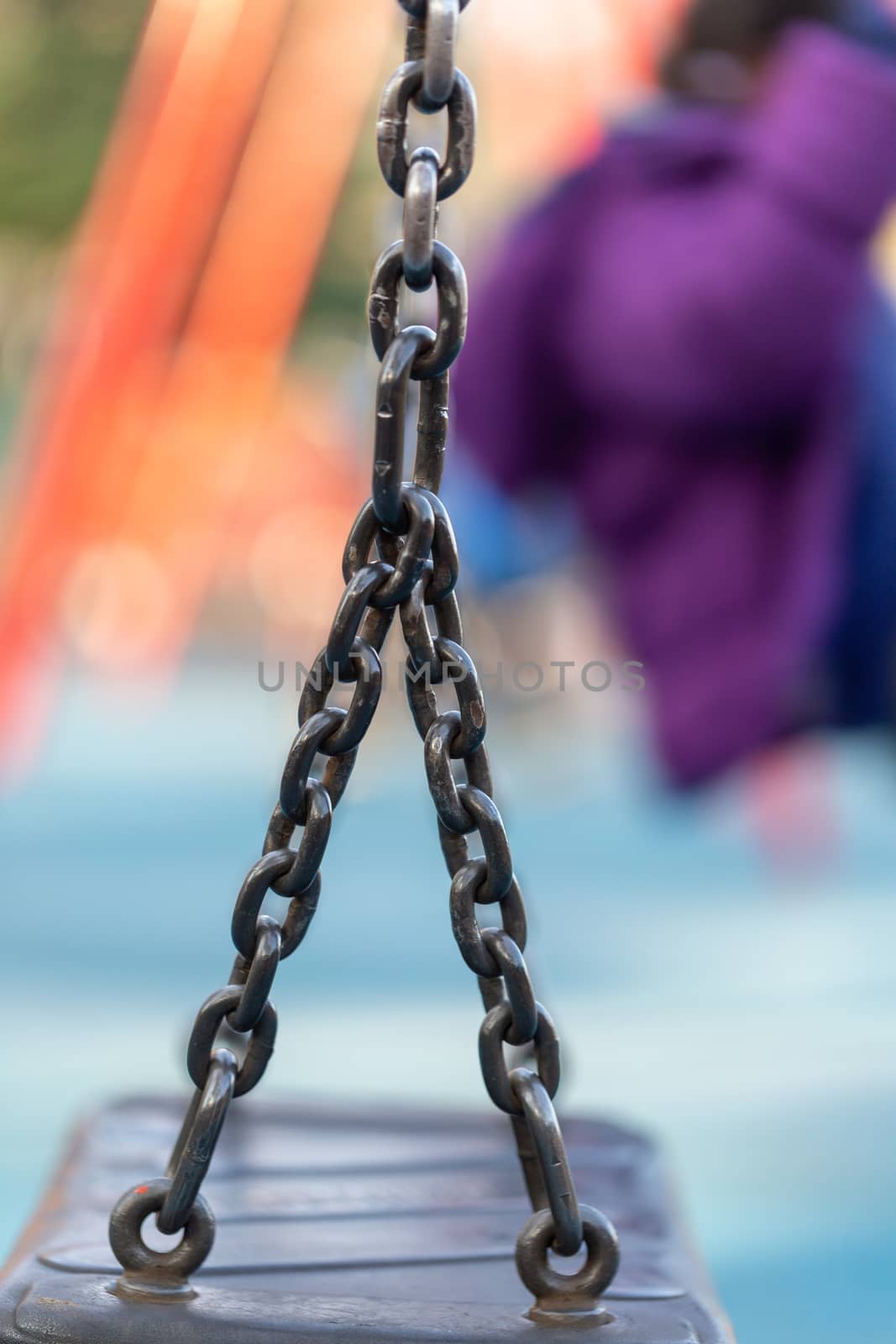 Blurred image of swings in a playground setting by magicbones