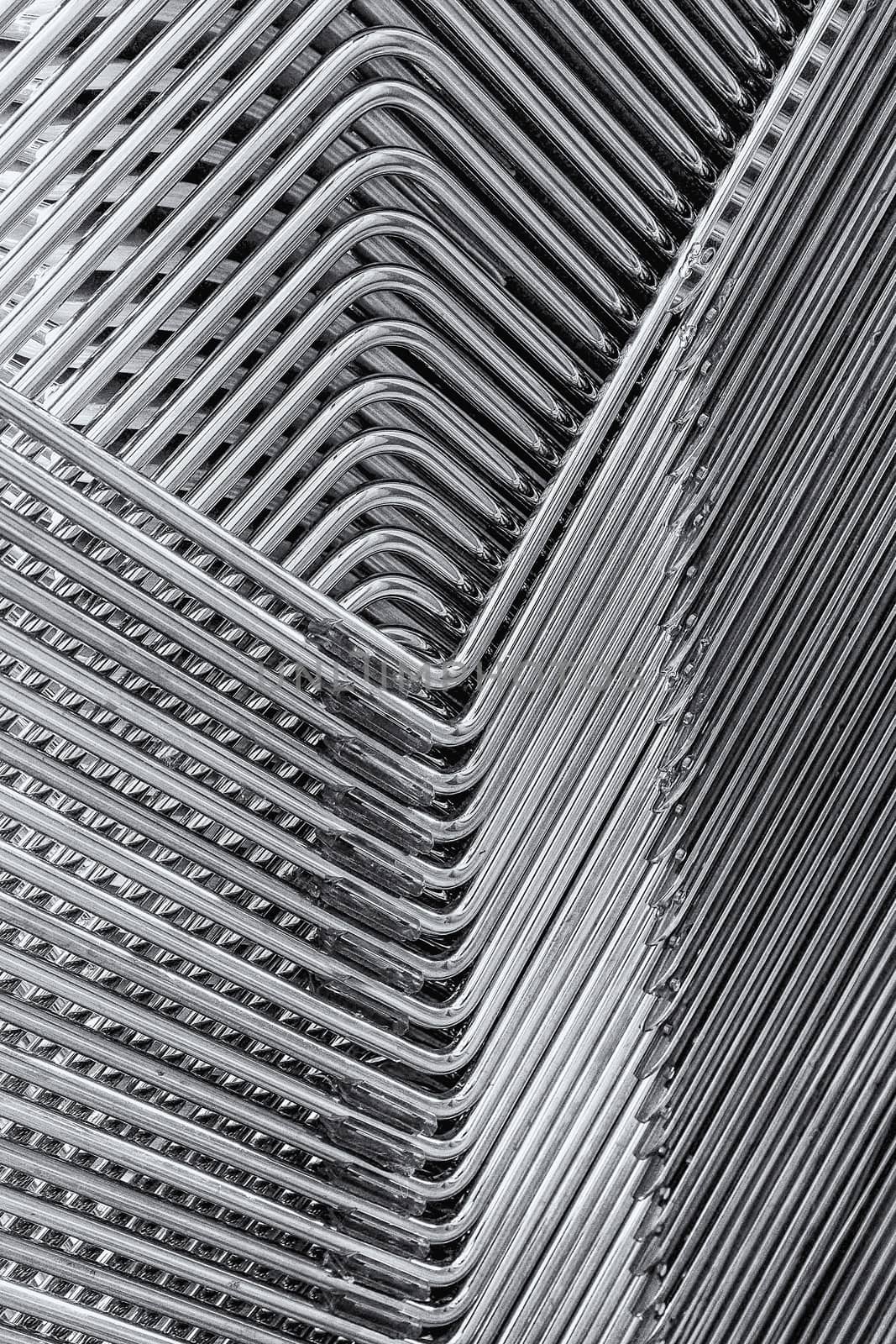 Abstract image of the metallic legs of stacked chairs