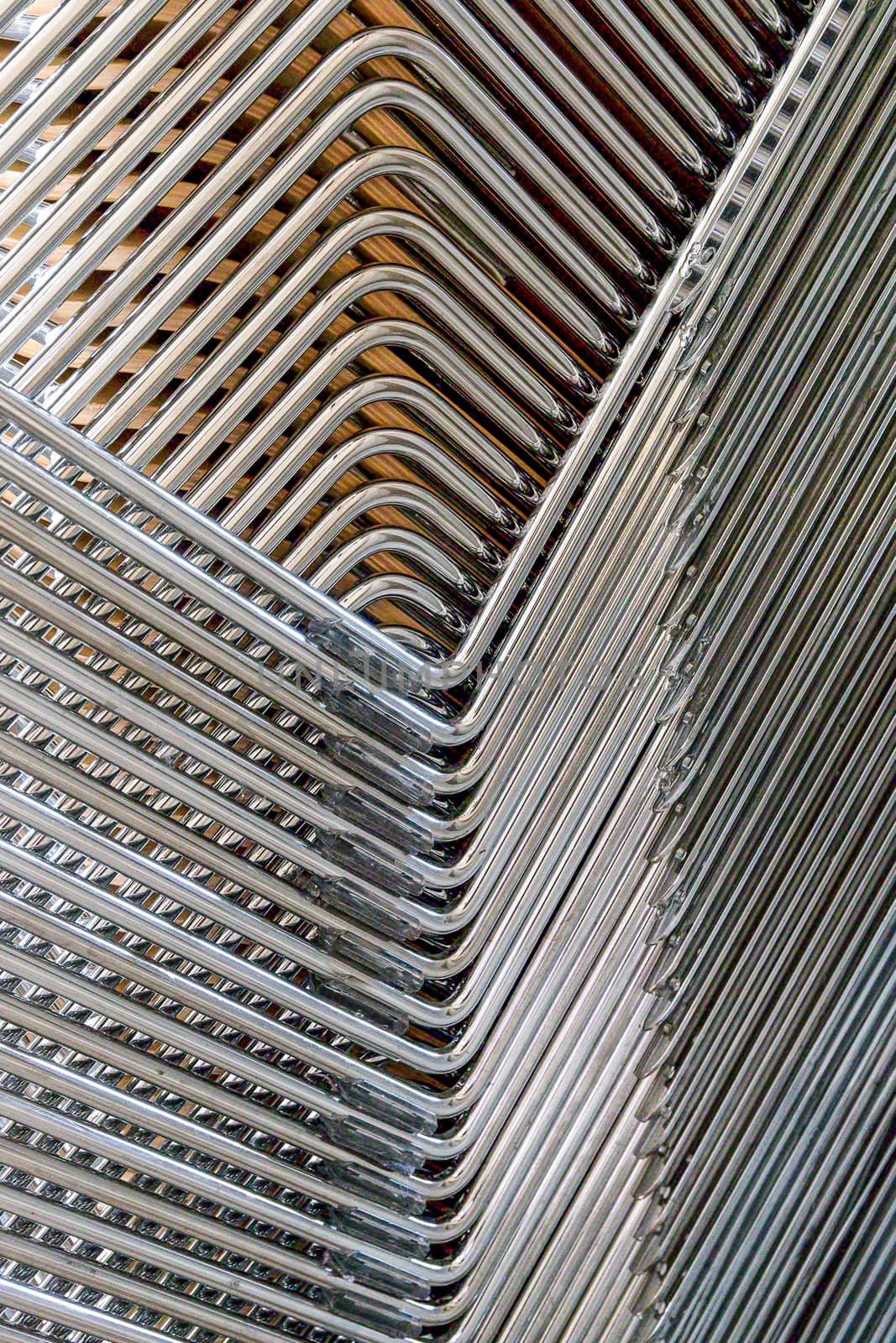 Abstract image of the metallic legs of stacked chairs